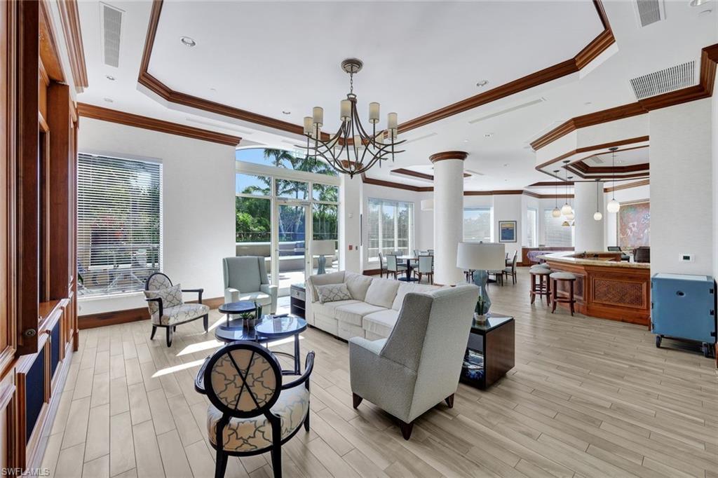 1060 Borghese Lane, Unit 1005 Naples, FL 34114 - Photo 25 of 38 a living room with furniture and a chandelier