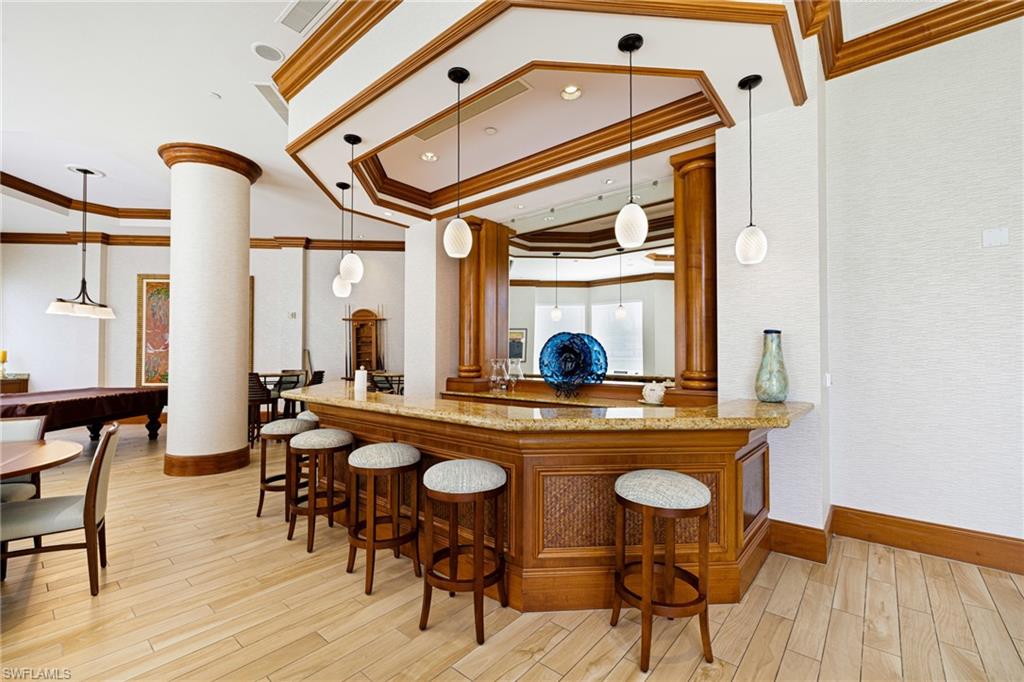 1060 Borghese Lane, Unit 1005 Naples, FL 34114 - Photo 28 of 38 a view of a dining room with furniture and wooden floor
