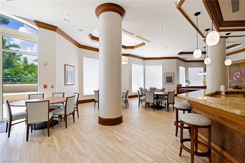 1060 Borghese Lane, Unit 1005 Naples, FL 34114 - Photo 29 of 38 a view of a dining room with furniture and wooden floor