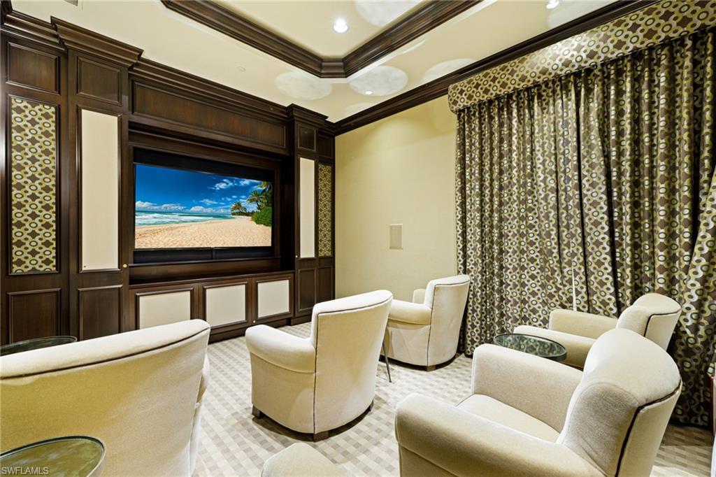 1060 Borghese Lane, Unit 1005 Naples, FL 34114 - Photo 34 of 38 a living room with furniture and a flat screen tv