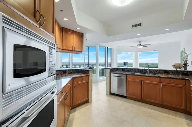 a kitchen with stainless steel appliances granite countertop a stove and a microwave