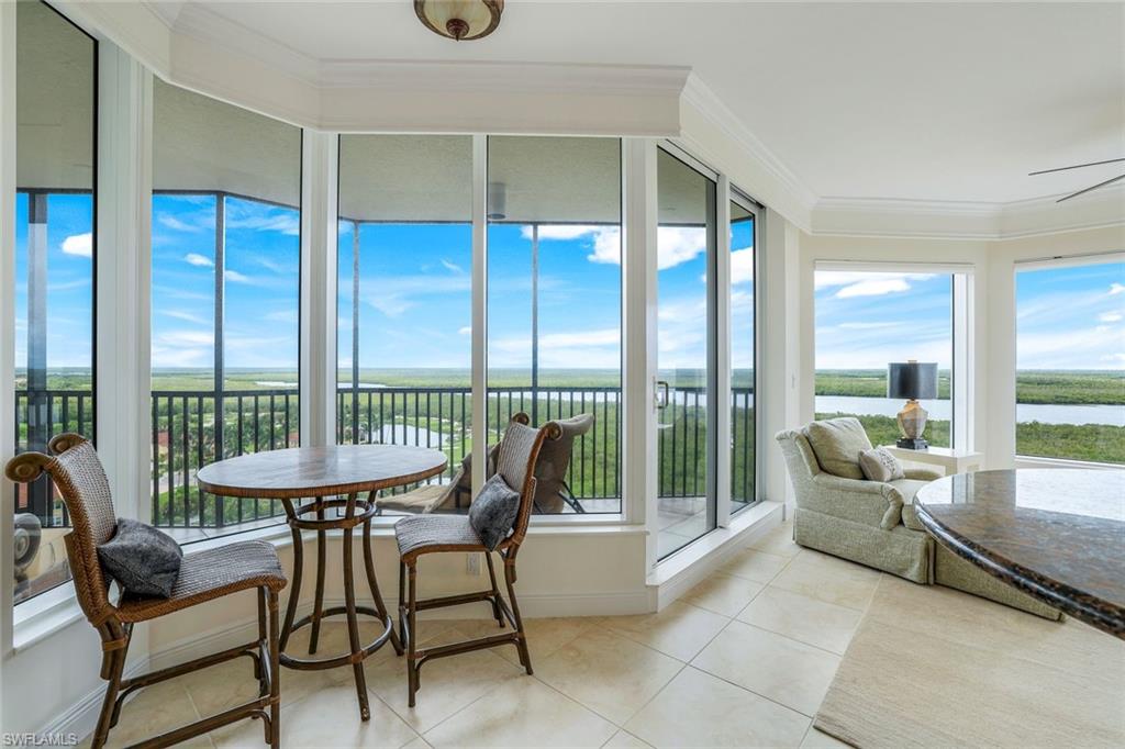 1060 Borghese Lane, Unit 1005 Naples, FL 34114 - Photo 9 of 38 a living room with furniture and a large window
