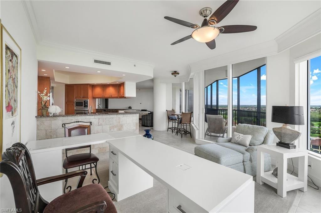 1060 Borghese Lane, Unit 1005 Naples, FL 34114 - Photo 10 of 38 a living room with furniture a flat screen tv and a large window