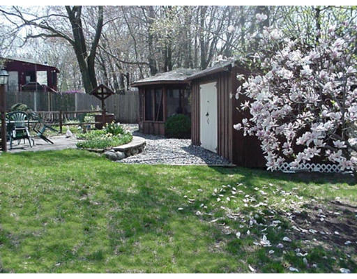 33 Woodbury Road Billerica, MA 01821 - Photo 3 of 4 a view of backyard of house with outdoor seating and green space