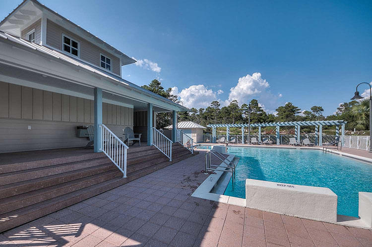 83 Constant Avenue Santa Rosa Beach, FL 32459 - Photo 13 of 19 a view of a patio with couches table and chairs with wooden floor and fence
