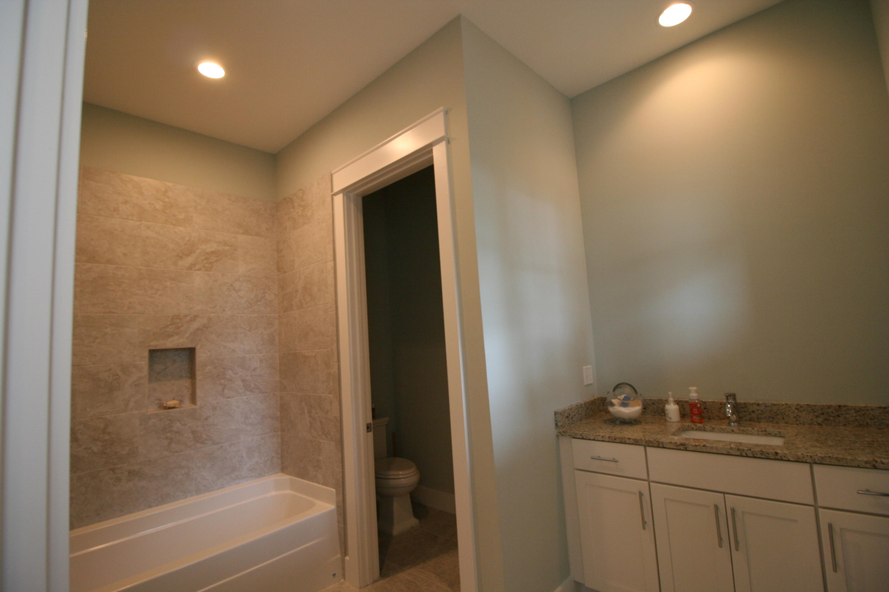 83 Constant Avenue Santa Rosa Beach, FL 32459 - Photo 19 of 19 a bathroom with a granite countertop sink a toilet and bathtub