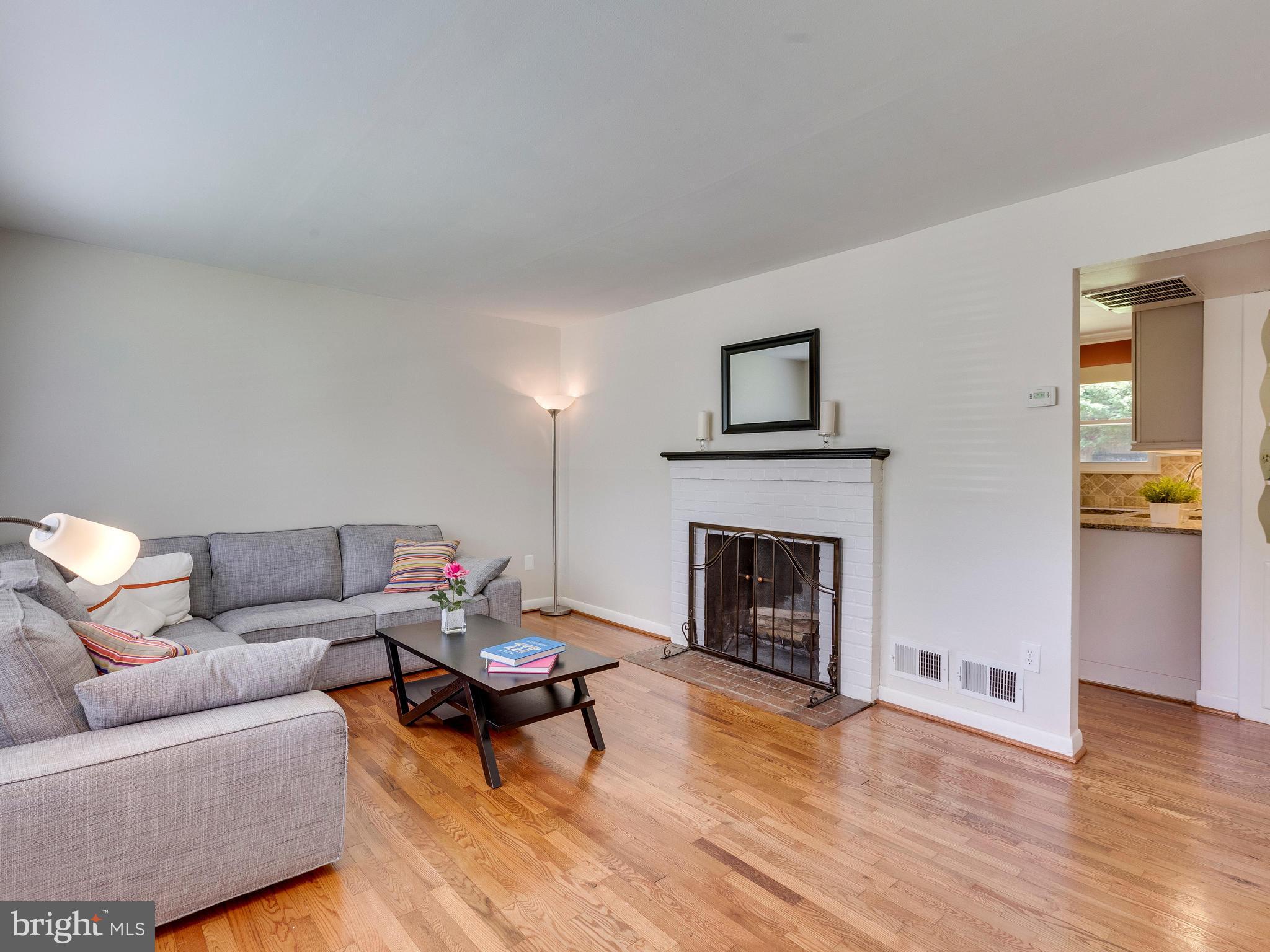 913 Robin Road Silver Spring, MD 20901 - Photo 3 of 30 Wood fireplace is heart of the cozy living room