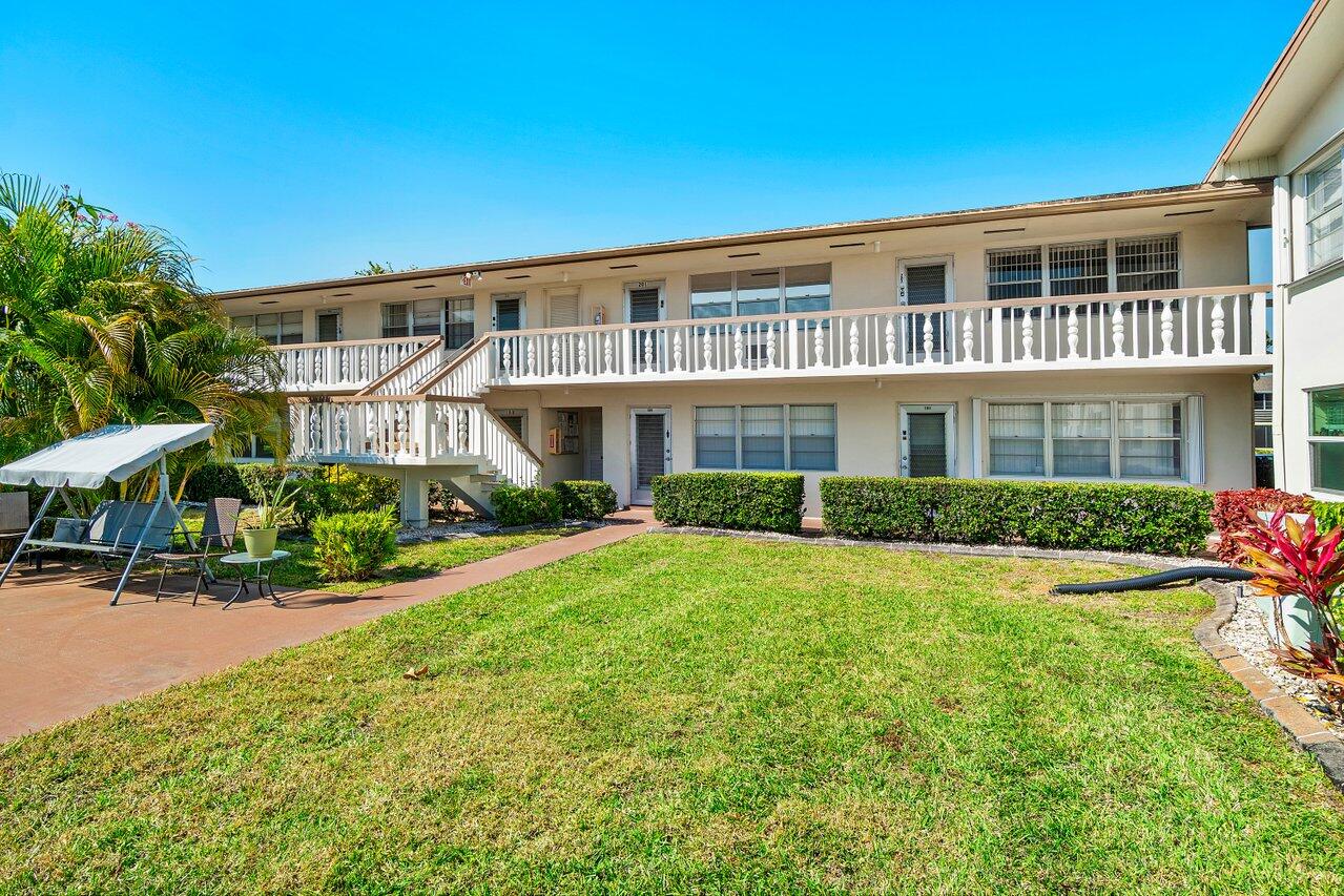 202 Windsor I West Palm Beach, FL 33417 - Photo 1 of 24 a front view of a house with a yard