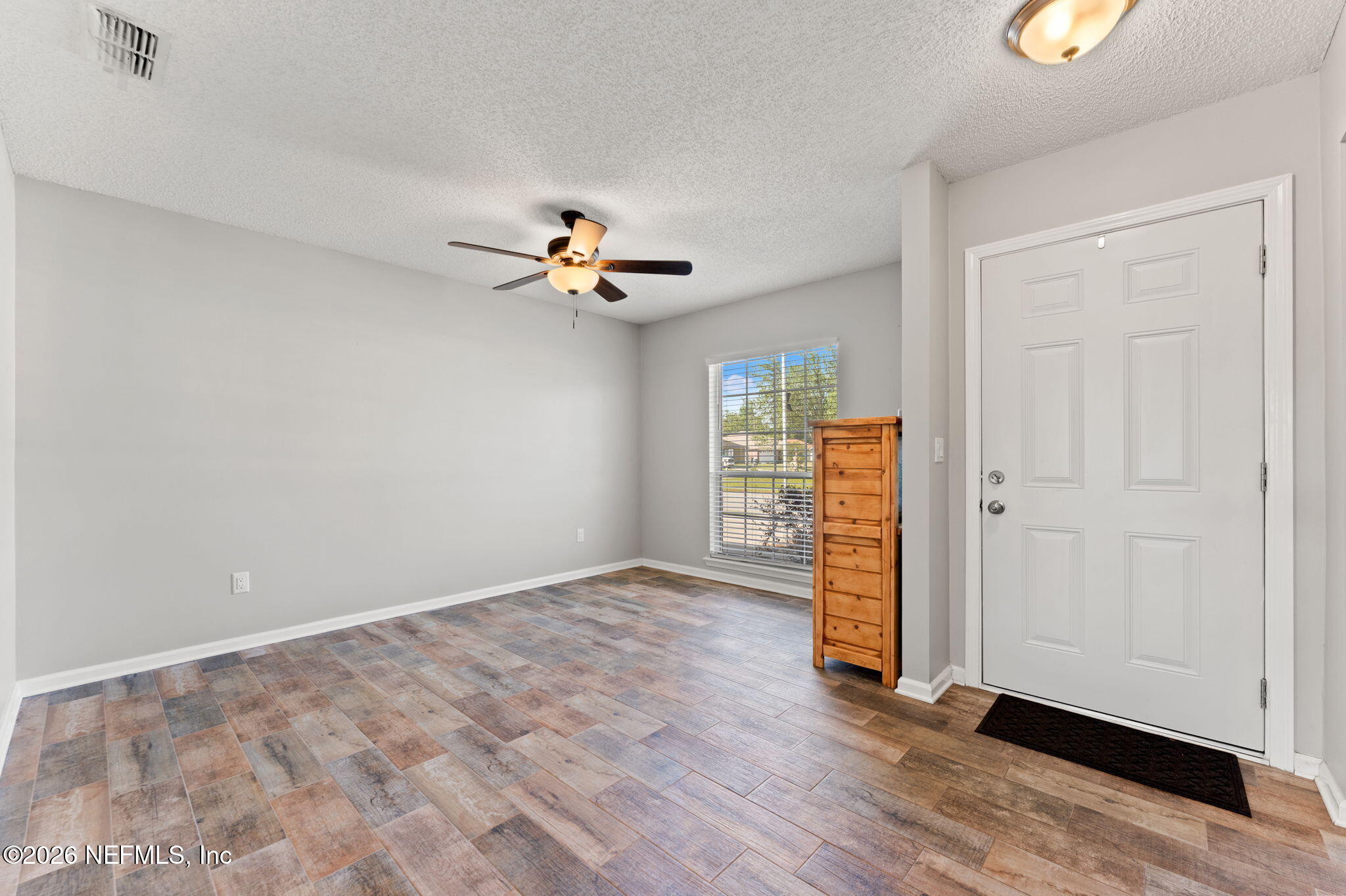 2982 Chief Ridaught Trail Middleburg, FL 32068 - Photo 9 of 29 wooden floor in an empty room with a window