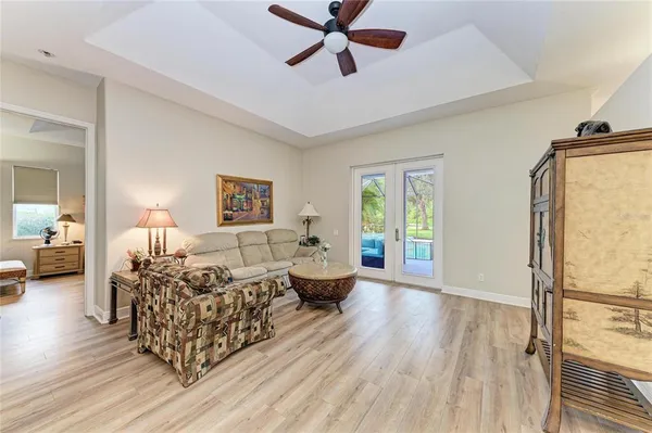 a living room with furniture and a wooden floor