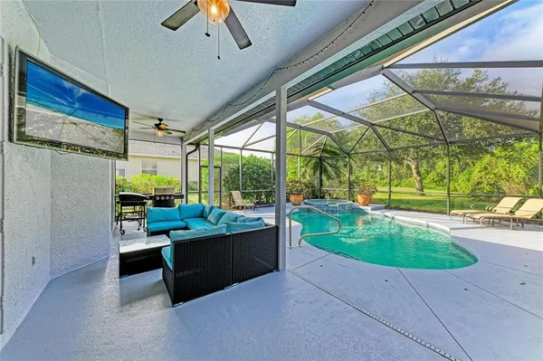 an aerial view of a house with pool yard and outdoor seating