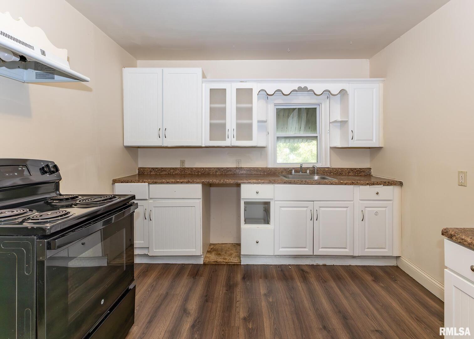 633 7th Avenue South Clinton, IA 52732 - Photo 15 of 19 a kitchen with granite countertop cabinets stainless steel appliances and wooden floor