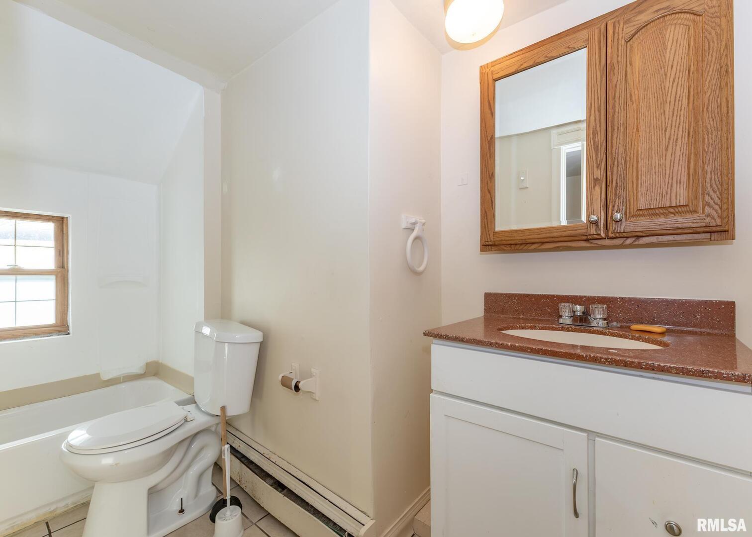633 7th Avenue South Clinton, IA 52732 - Photo 19 of 19 a bathroom with a sink a toilet and a mirror