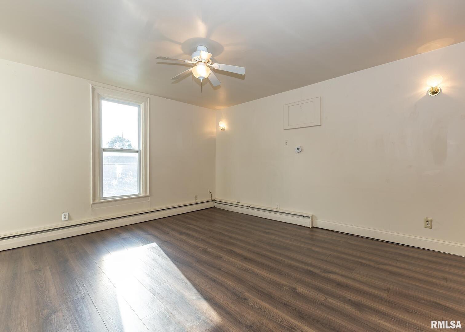 633 7th Avenue South Clinton, IA 52732 - Photo 9 of 19 an empty room with wooden floor and windows