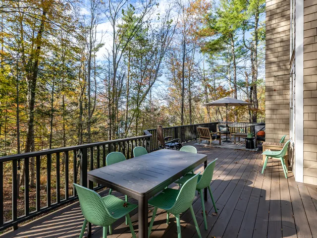 a view of backyard with outdoor seating and wooden floor