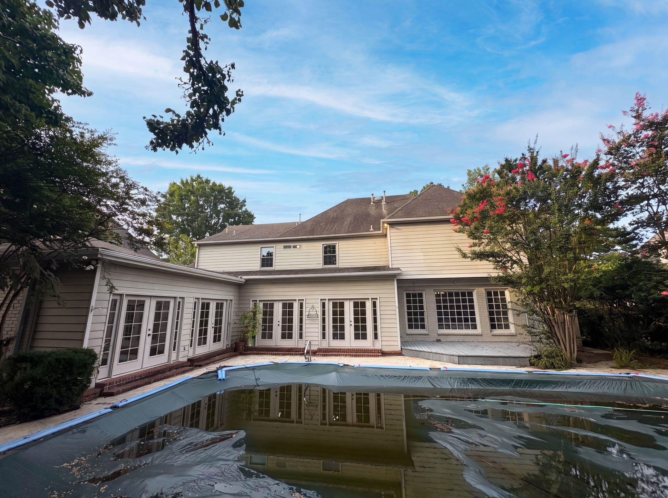 9424 Gotten Road Germantown, TN 38139 - Photo 5 of 27 Rear exterior featuring a covered swimming pool, multiple sets of French doors, a ground-level deck, bay windows, and siding construction