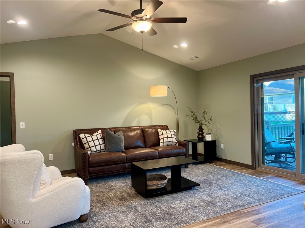 5531 Innkeeper Street Southeast Dennison, OH 44621 - Photo 9 of 30 Living room with ceiling fan, hardwood / wood-style flooring, and lofted ceiling