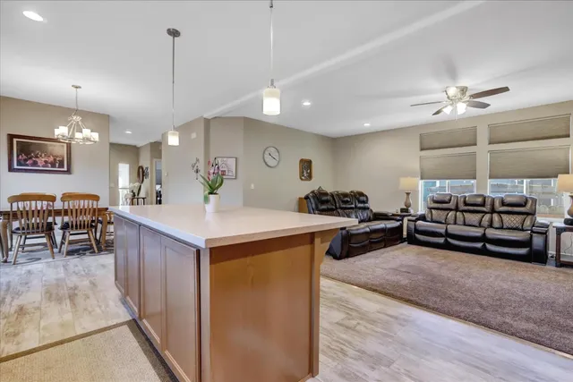 a living room with furniture and kitchen view