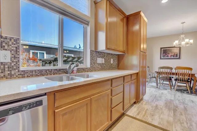 a kitchen with stainless steel appliances granite countertop a sink and a cabinets
