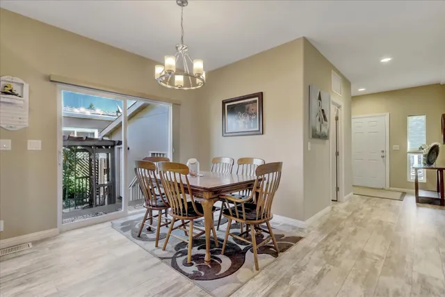 a view of a dining room with furniture and chandelier