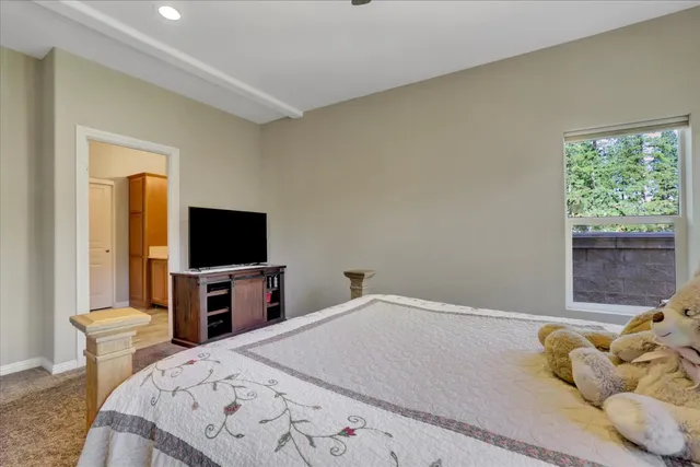 a bedroom with a bed and a flat screen tv