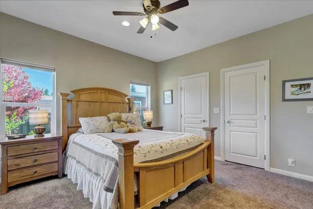a bedroom with a bed and a chandelier