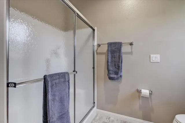 a bathroom with a shower and a sink