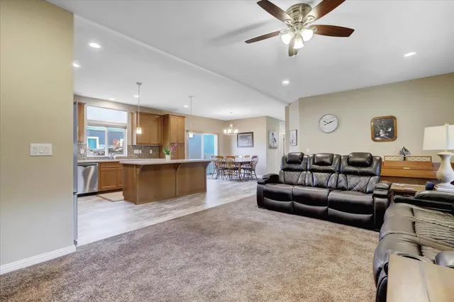 a living room with furniture and kitchen view