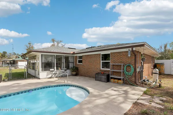 a view of a backyard with swimming pool