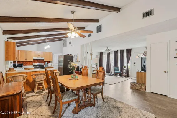 a kitchen with stainless steel appliances granite countertop a stove a sink dishwasher and a microwave oven with cabinets