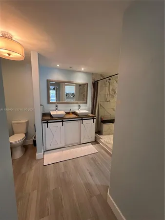 a large white kitchen with a sink dishwasher a stove and a refrigerator