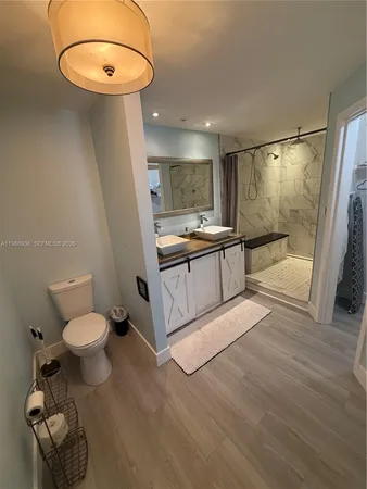 a living room with furniture wooden floor and dining room