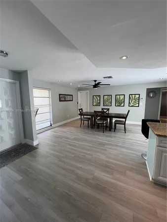 a kitchen with stainless steel appliances granite countertop a stove a sink and white cabinets