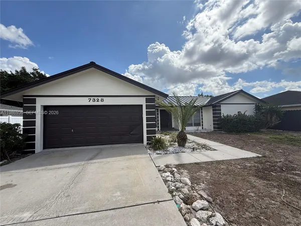 a front view of a house with garage