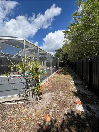 a view of a house with backyard and porch