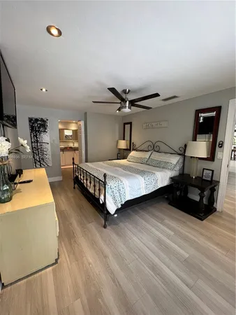 a bedroom with a bed and a night stand