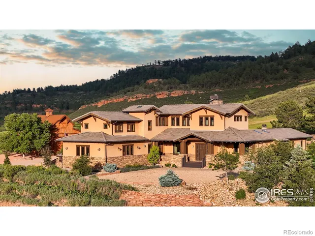 a front view of a house with a yard and lake view