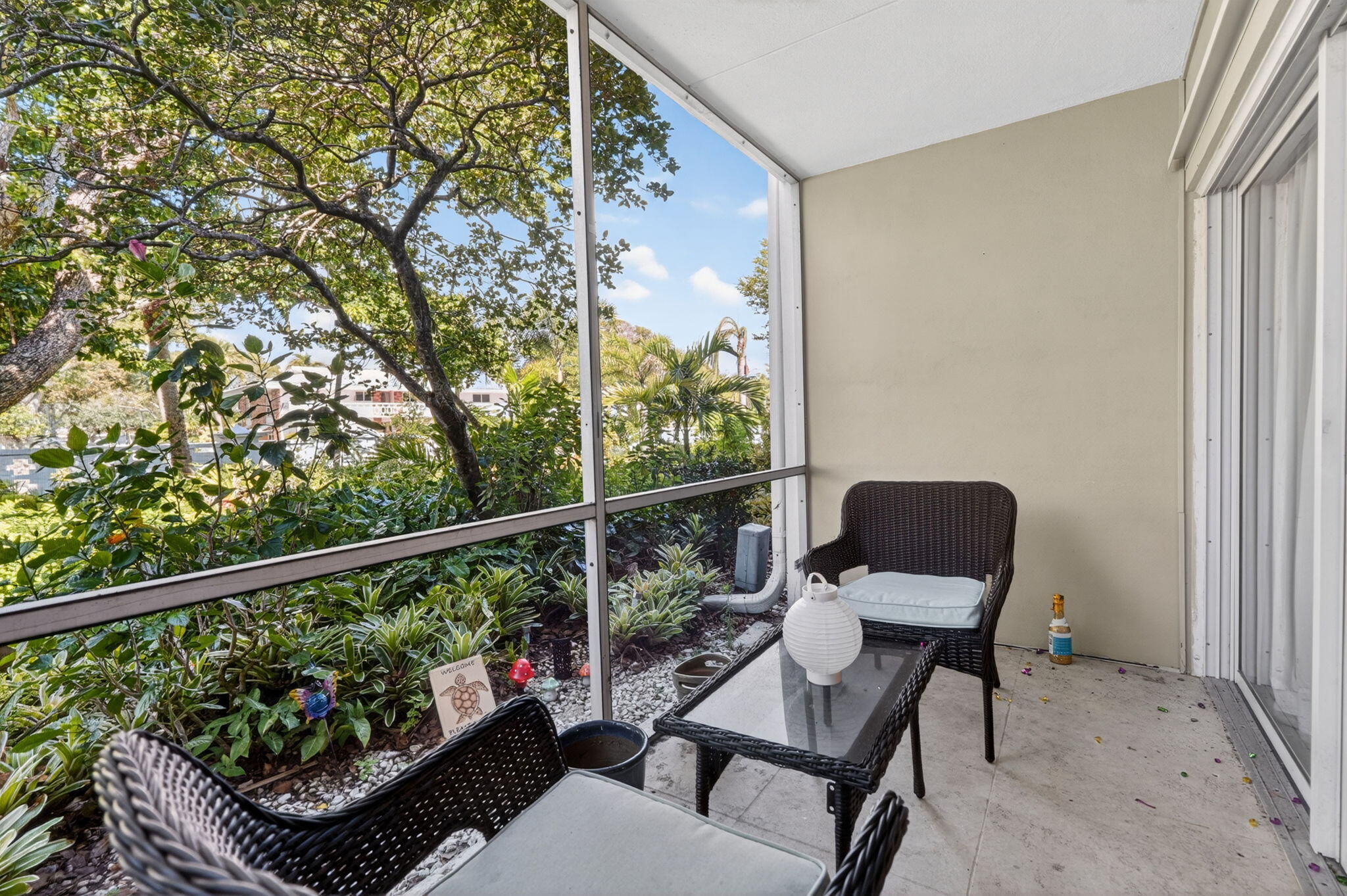 91 Willow Road, Unit 104 Tequesta, FL 33469 - Photo 10 of 25 Screen Porch w/ Garden Views