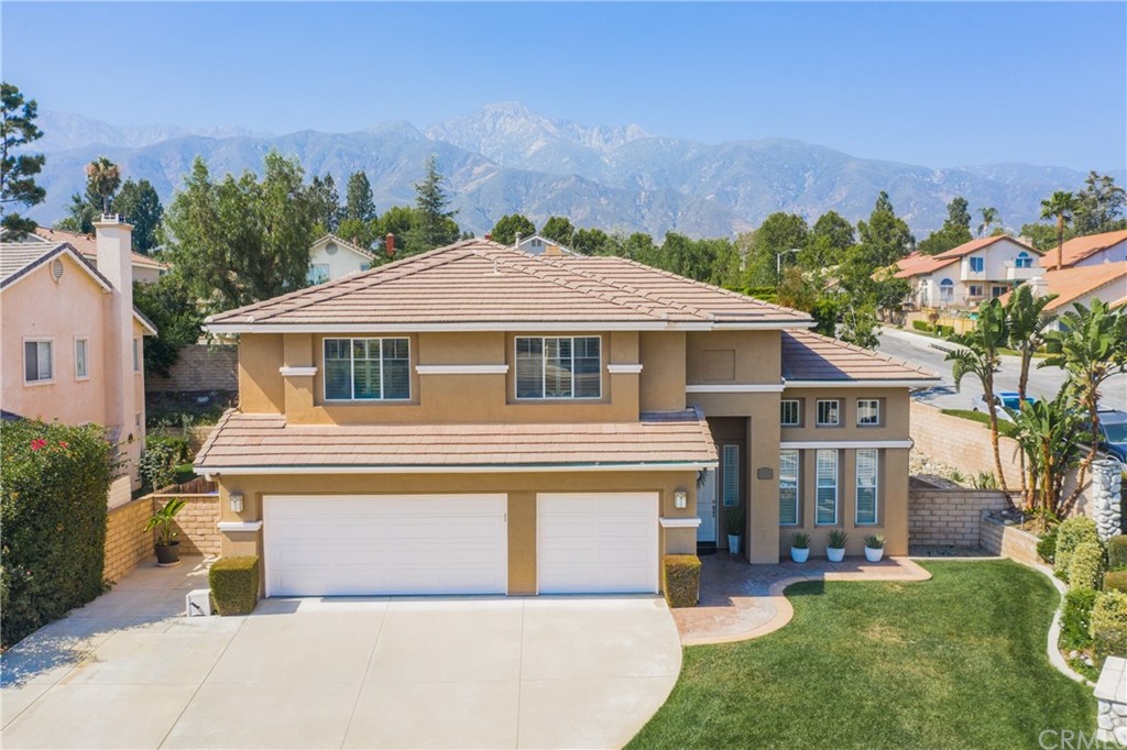 10194 Thorpe Court Rancho Cucamonga, CA 91737 - Photo 1 of 1 a front view of a house with a garden and plants