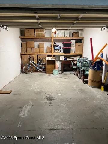 a view of a patio with table and chairs potted plants and palm tree