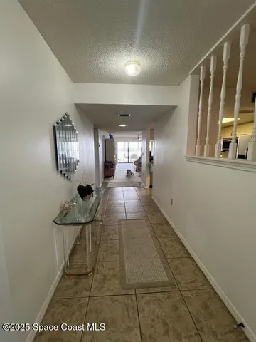 a living room with furniture a chandelier and a large window