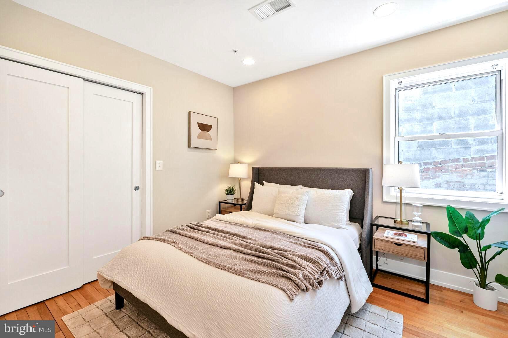 2515 17th Street Northwest, Unit 5 Washington, DC 20009 - Photo 11 of 14 a bedroom with a bed and a potted plant