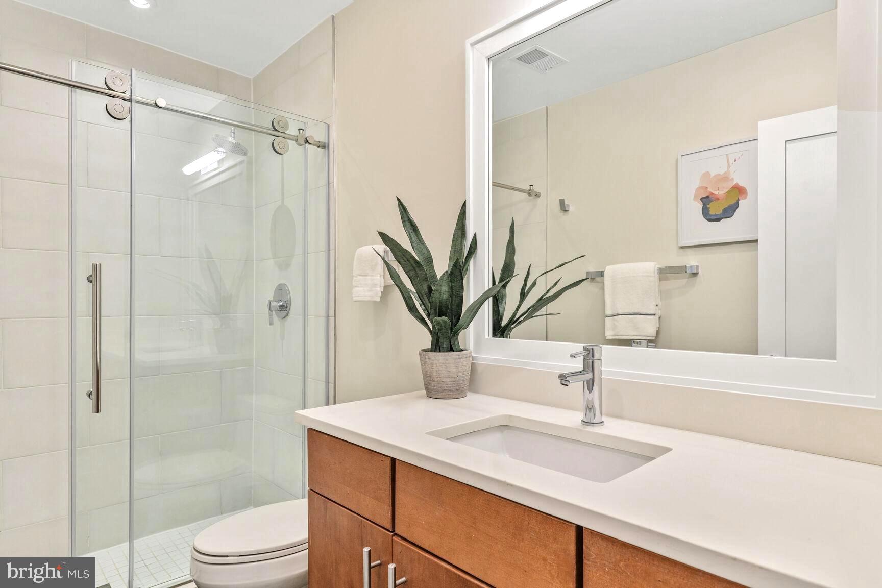 2515 17th Street Northwest, Unit 5 Washington, DC 20009 - Photo 12 of 14 a bathroom with a granite countertop sink a toilet and shower