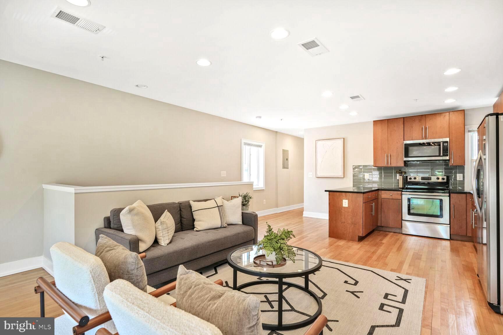 2515 17th Street Northwest, Unit 5 Washington, DC 20009 - Photo 2 of 14 a living room with stainless steel appliances kitchen island granite countertop furniture and wooden floor