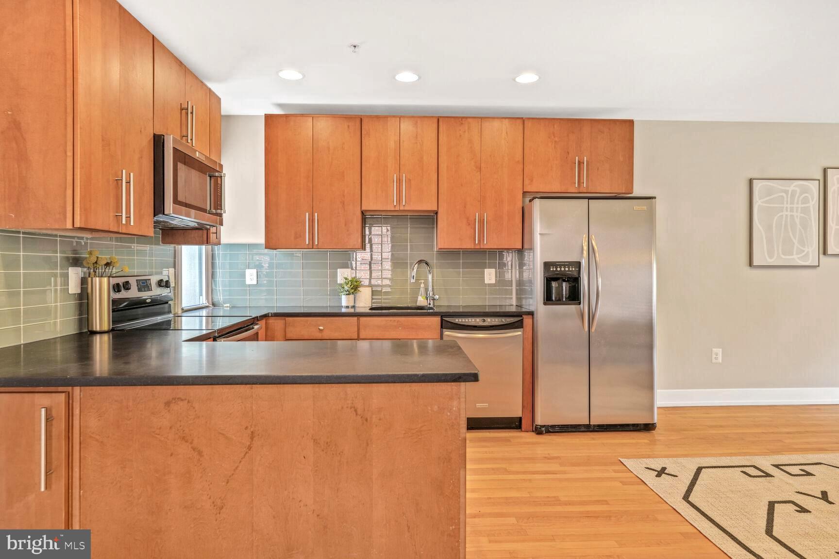2515 17th Street Northwest, Unit 5 Washington, DC 20009 - Photo 3 of 14 a kitchen with stainless steel appliances granite countertop a refrigerator a stove a sink and a microwave