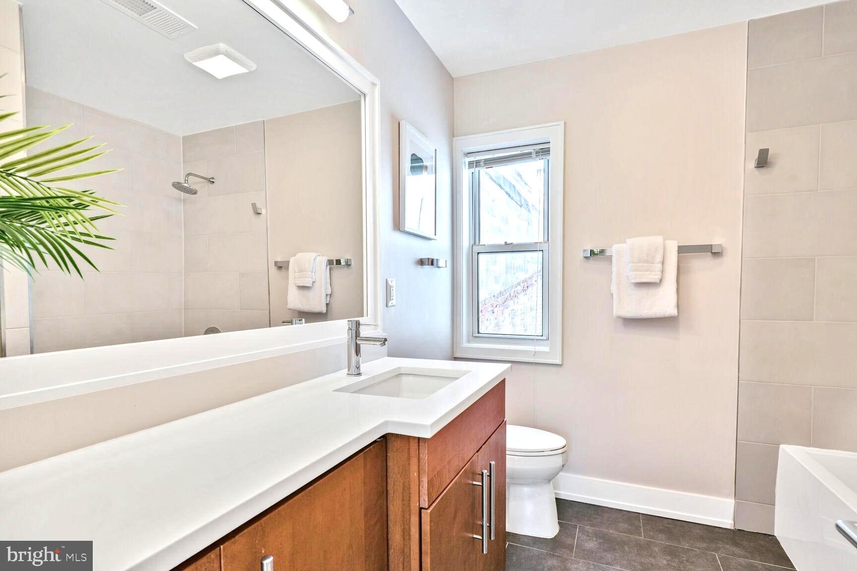 2515 17th Street Northwest, Unit 5 Washington, DC 20009 - Photo 10 of 14 a bathroom with a sink a toilet and shower