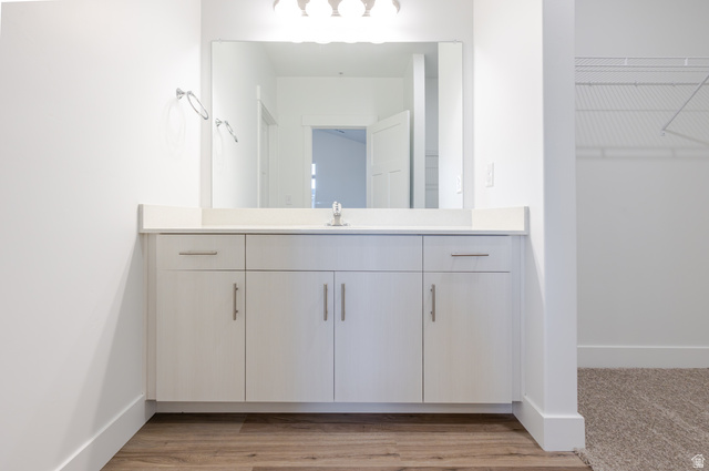 4661 Poplar Way, Unit R304 Mapleton, UT 84664 - Photo 9 of 17 Bathroom featuring a spacious closet, vanity, and light wood-style flooring