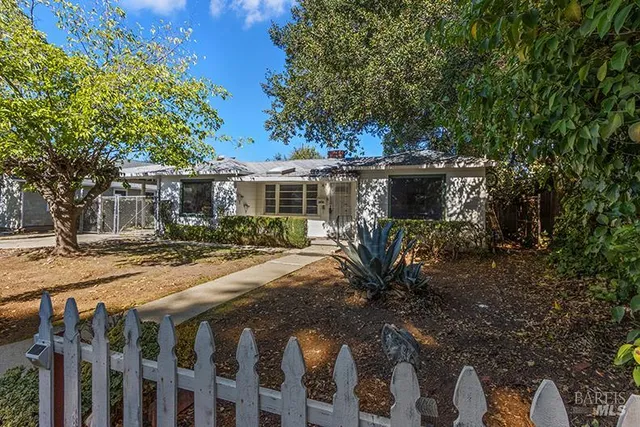 a view of a house with backyard and sitting area
