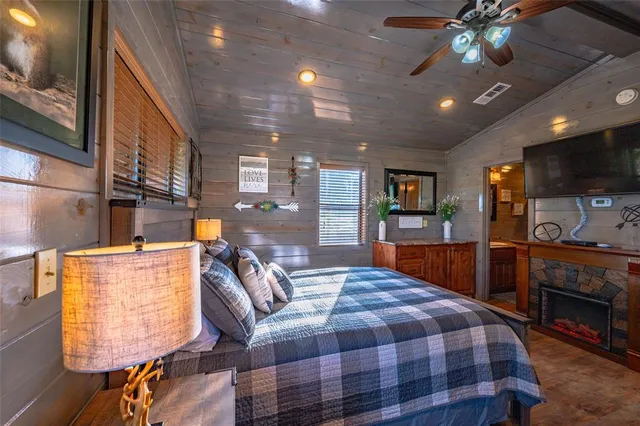 a bed room with furniture and a flat screen tv