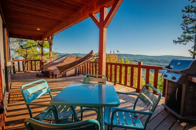 a balcony with chairs and a table